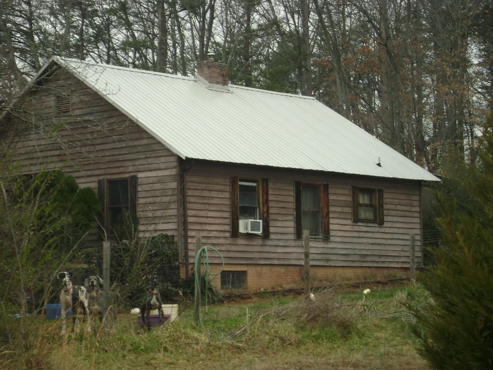 White metal roof on an old wood sided farmhouse, from a Metal Roof Installation job in Brookshire